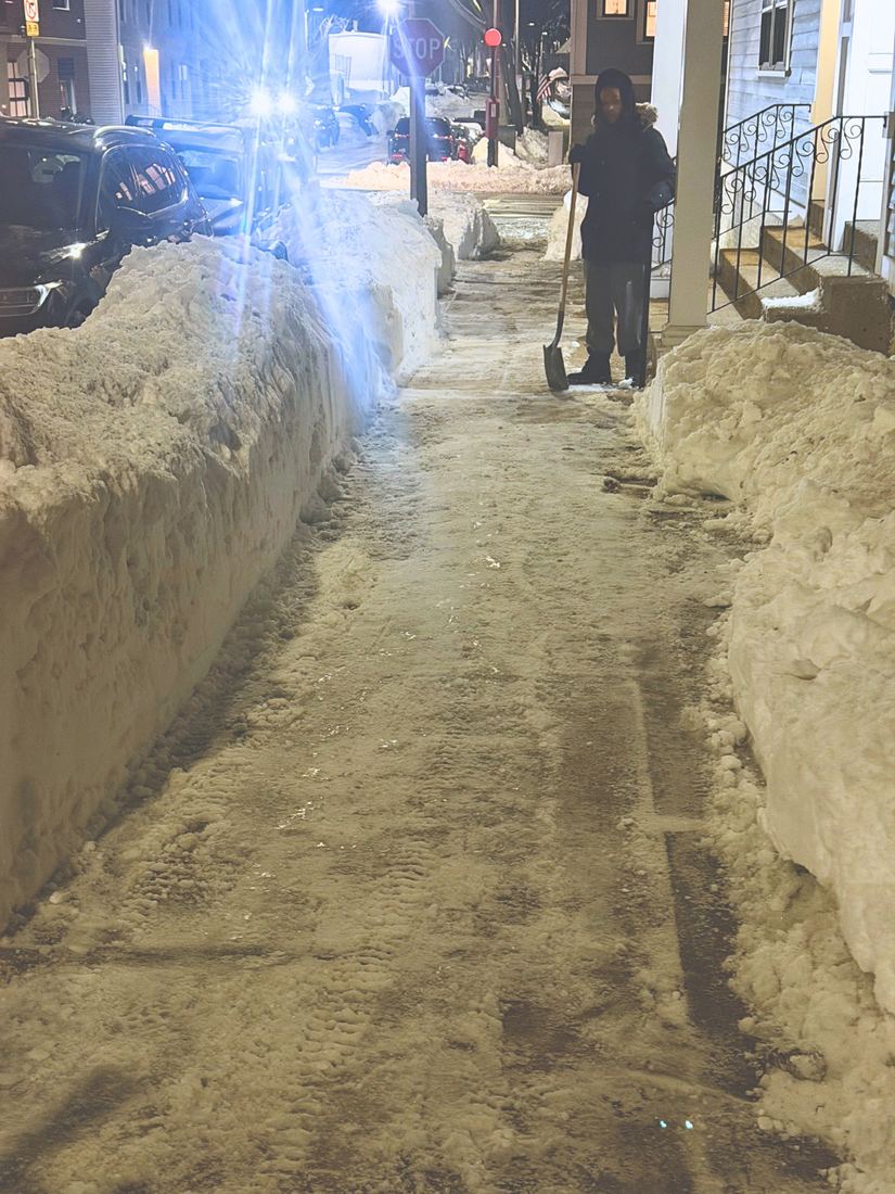 A.T. Property Services crew member on the winter route in South Boston, at night after a storm