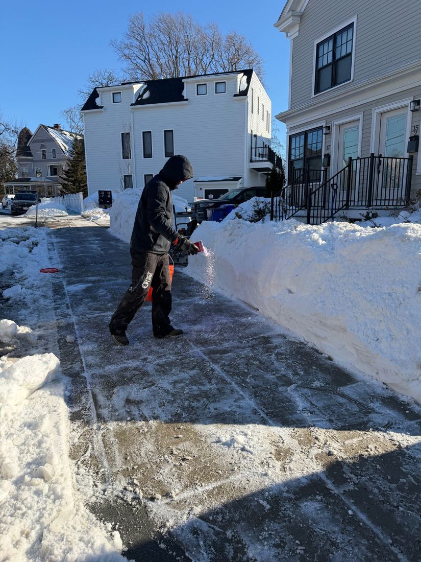 A.T. Property Services applying salt to a cleared South Boston driveway