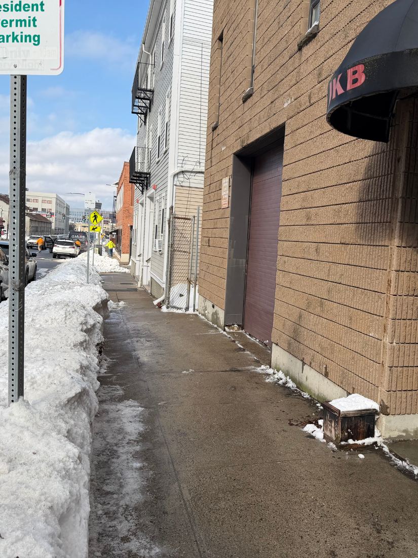 Cleared sidewalk beside a South Boston commercial building