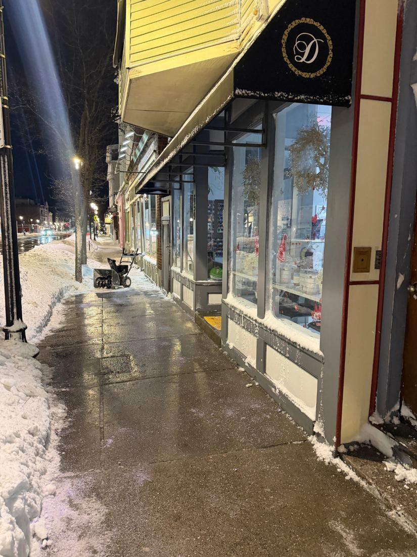 Cleared storefront sidewalk on a South Boston commercial block